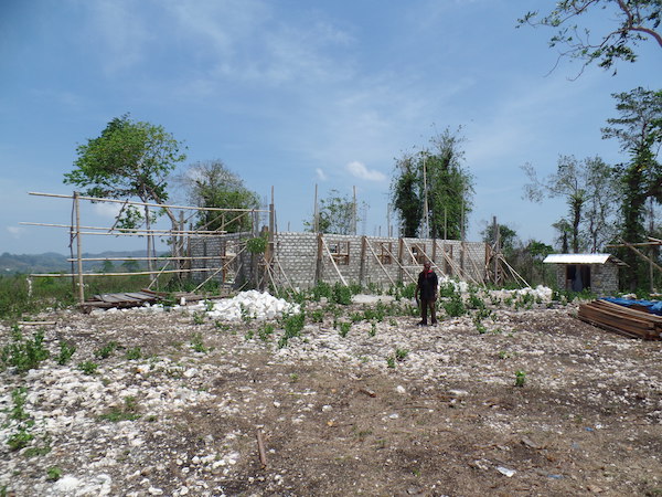 The Village Head shows the new Village Office in Matawai Kajawi that is being built at the top of a hill formerly just used for herding buffalo - Jacqueline Vel, Sumba, November 2014.