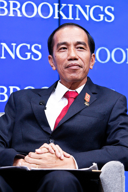 President Joko Widodo sitting with a smile at a Brookings Institution event.