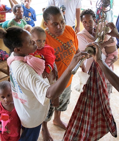 Women tracking the weight of their babies in Posyandu Services, Ginggimop Village, north of Tanah Merah  Bobby Anderson