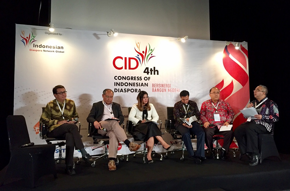 A panel of six sit on a small stage in front of a banner at the 4th Congress of Indonesian Diaspora. (Yearry Panji Setianto)